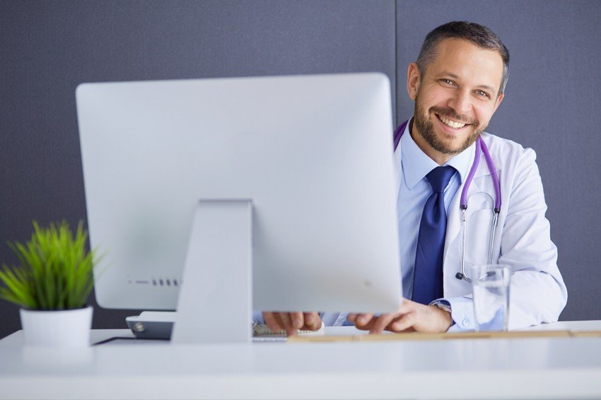 A male doctor using Ace QBank software at a desk while preparing for the MCCQE1 exam.