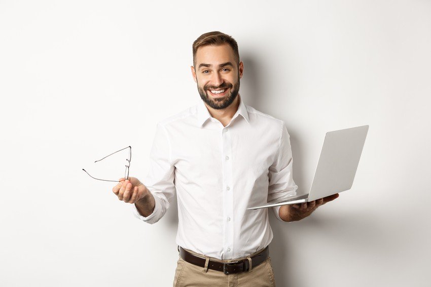 A Medical graduate holding a laptop searching for the MCCQE1 exam format.