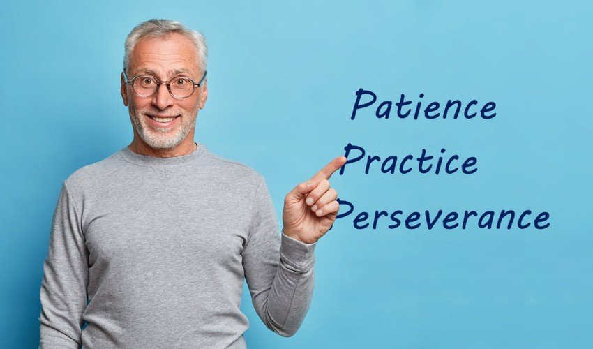 A smiling man pointing to words "patience, practice, perseverance" written in the air beside him, highlighting key strategies for PLAB exam preparation.