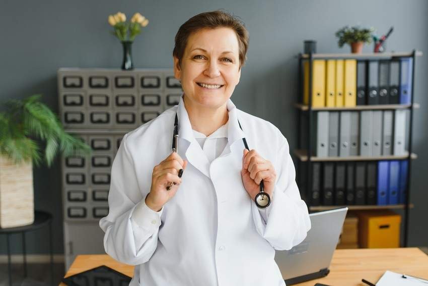 Confident doctor standing in an office with a stethoscope, preparing for the PLAB exam with Ace QBank.