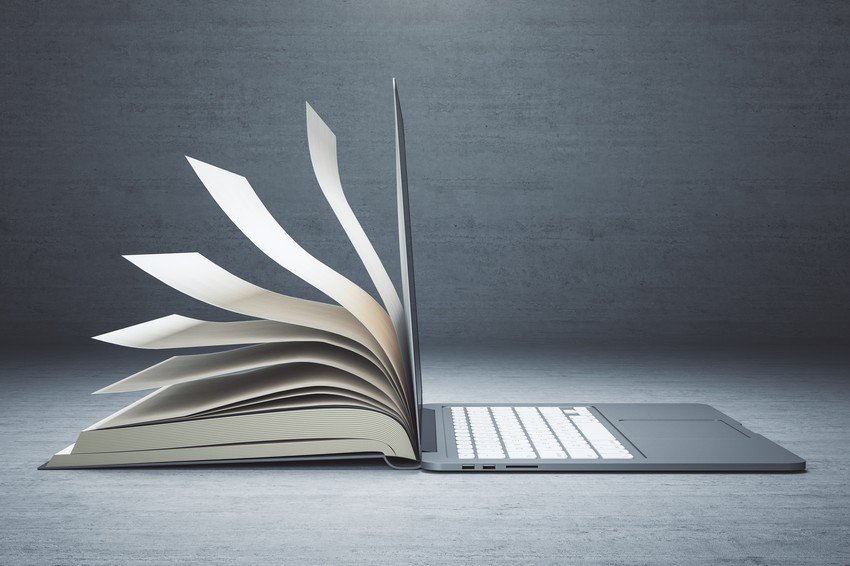 An open book with pages transforming into a digital laptop on a gray background, symbolizing MCCQE1 exam preparation.