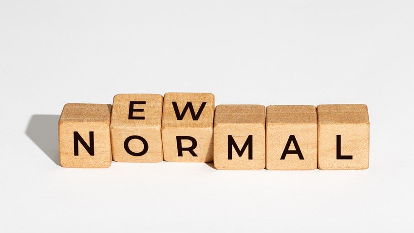 Wooden blocks spelling "NEW NORMAL," with the blocks slightly misaligned on a white background, symbolize the changes to the MCCQE Part I in 2025.