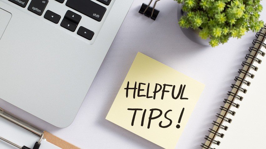 A sticky note with “HELPFUL TIPS!” is placed on a desk next to a laptop, Ace QBank materials for MCCQE Part 1 Prep, a potted plant, a notebook, and some binder clips.