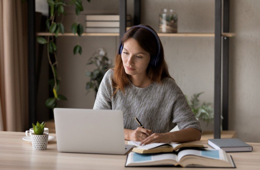 Women study on a laptop on, using Ace QBank for MCCQE1 Exam Prep.