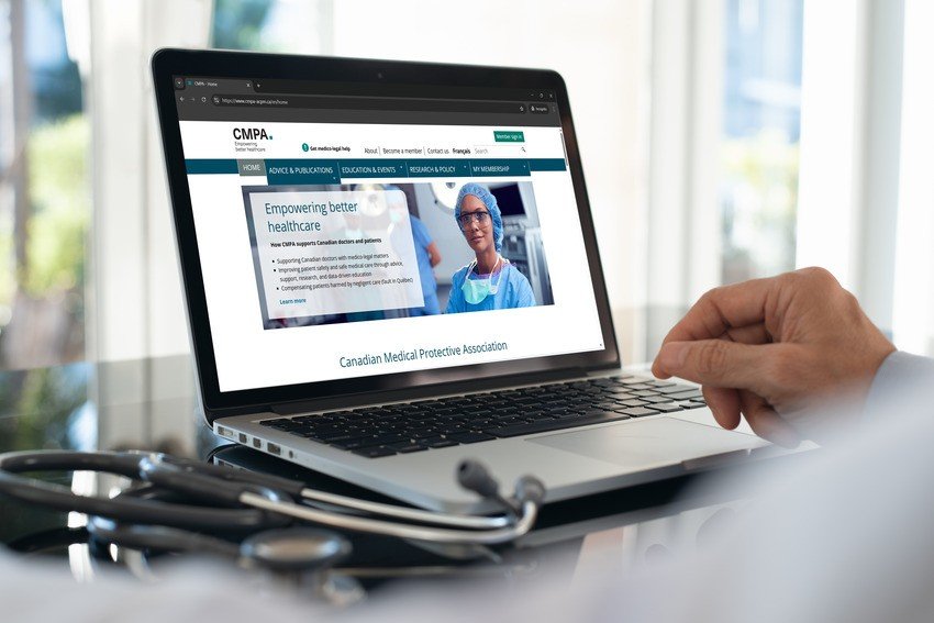 A person uses a laptop displaying the Canadian Medical Protective Association website, with a stethoscope resting on the table beside the computer, researching Ace QBank resources for MCCQE1 and information about doctor salaries in Canada.